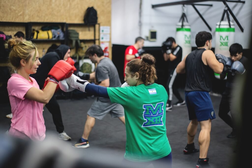 A group of adults training boxing in an indoor gym in Buenos Aires, Argentina.